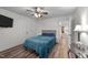 Bedroom with wood-look floors, comfortable bed, and connected hall access at 260 Crestdale Dr, Clayton, NC 27520