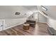 Attic bonus room with a comfortable futon, unique table, and ample lighting at 260 Crestdale Dr, Clayton, NC 27520