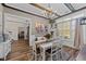 Traditional dining room with hardwood floors, wood beam ceiling, white wainscoting, and lots of natural light at 260 Crestdale Dr, Clayton, NC 27520