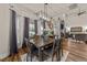 Dining room with hardwood floors, modern chandelier, and natural light with direct access to the living room at 260 Crestdale Dr, Clayton, NC 27520