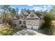 Attractive two-story home with a stone-accented facade, covered porch, and convenient two-car garage at 260 Crestdale Dr, Clayton, NC 27520
