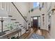 Bright and airy foyer featuring a staircase, hardwood floors, and a view of the front door at 260 Crestdale Dr, Clayton, NC 27520