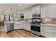 Spacious kitchen with white cabinets, stainless appliances, granite countertops, and hardwood floors at 260 Crestdale Dr, Clayton, NC 27520