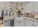 Modern kitchen with white cabinets, granite countertops, stainless steel appliances, and a farmhouse sink at 260 Crestdale Dr, Clayton, NC 27520