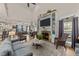 Inviting living room with a stone fireplace, built-in shelving, and a cozy seating area at 260 Crestdale Dr, Clayton, NC 27520