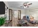 Cozy living room featuring a comfortable sofa, stylish decor, and wood flooring at 260 Crestdale Dr, Clayton, NC 27520