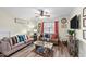 Inviting living room with comfortable seating, ceiling fan, and decorative elements at 260 Crestdale Dr, Clayton, NC 27520