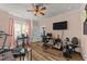 Inviting living room with ceiling fan, wood floors, and space for workout equipment at 260 Crestdale Dr, Clayton, NC 27520