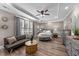 Serene primary bedroom features tray ceilings, a ceiling fan, and an abundance of natural light at 260 Crestdale Dr, Clayton, NC 27520