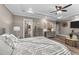 Bright primary bedroom features hardwood floors, neutral-colored walls, and walk-in bathroom at 260 Crestdale Dr, Clayton, NC 27520