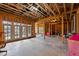 Spacious unfinished basement featuring concrete floors, exposed wooden beams, and natural light at 2635 Lakeview Dr, Raleigh, NC 27609