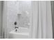 Clean bathroom featuring a white tiled tub and shower combination with sleek fixtures at 2635 Lakeview Dr, Raleigh, NC 27609
