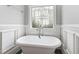 Serene bathroom featuring a standalone soaking tub and decorative stained glass window at 2635 Lakeview Dr, Raleigh, NC 27609