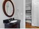 Elegant bathroom featuring a dark vanity with granite countertop and oval mirror at 2635 Lakeview Dr, Raleigh, NC 27609