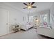 Bright bedroom featuring two twin beds, ceiling fan, and natural light from large windows at 2635 Lakeview Dr, Raleigh, NC 27609