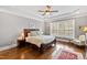 Comfortable bedroom with a large bed, hardwood floors, and bright natural light at 2635 Lakeview Dr, Raleigh, NC 27609