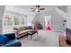 Spacious bonus room with natural lighting, a comfortable sofa, and ample space for recreation at 2635 Lakeview Dr, Raleigh, NC 27609