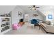 Bonus room with sloped ceilings featuring a TV, furnishings, custom shelving, and ample natural light at 2635 Lakeview Dr, Raleigh, NC 27609
