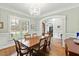 Formal dining room with a large table, chandelier, and paneled walls at 2635 Lakeview Dr, Raleigh, NC 27609