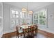 Bright dining room with hardwood floors and large windows offering beautiful views, perfect for gatherings at 2635 Lakeview Dr, Raleigh, NC 27609