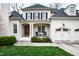 Charming white brick home with a front porch and two-car garage at 2635 Lakeview Dr, Raleigh, NC 27609