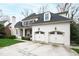 Side view of a white brick home with a well-manicured lawn and driveway at 2635 Lakeview Dr, Raleigh, NC 27609