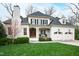 Elegant white brick home with a two-car garage and manicured lawn at 2635 Lakeview Dr, Raleigh, NC 27609