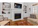This living room features a fireplace with white mantle and built-in bookshelves at 2635 Lakeview Dr, Raleigh, NC 27609