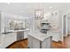 Bright kitchen boasts hardwood floors, white cabinets, granite countertops, pendant lighting and breakfast nook at 2635 Lakeview Dr, Raleigh, NC 27609
