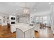 Gourmet kitchen features white cabinets, hardwood floors, stainless appliances, island and breakfast nook at 2635 Lakeview Dr, Raleigh, NC 27609