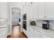 This kitchen features white cabinets, granite countertops, stainless steel appliances and subway tile backsplash at 2635 Lakeview Dr, Raleigh, NC 27609