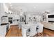 Open-concept kitchen with dual islands, stainless appliances, custom cabinets, and hardwood floors throughout at 2635 Lakeview Dr, Raleigh, NC 27609