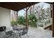 Relaxing covered patio with stone flooring, outdoor seating, and view of the landscaped backyard at 2635 Lakeview Dr, Raleigh, NC 27609