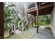 Back patio with stairs leading up to the second level and the landscaped backyard at 2635 Lakeview Dr, Raleigh, NC 27609