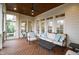Inviting covered porch with wood floors, ceiling fan, and plush outdoor furniture at 2635 Lakeview Dr, Raleigh, NC 27609