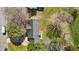 Aerial view of the home showcasing roof, surrounding trees, and yard space with an extended driveway at 309 Old Farm Dr, Graham, NC 27253