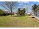 Expansive grassy backyard surrounded by trees, offering a peaceful outdoor retreat at 309 Old Farm Dr, Graham, NC 27253
