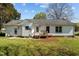 View of the backyard highlighting the home's rear exterior, back door, and expansive lawn space at 309 Old Farm Dr, Graham, NC 27253