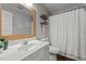 Bright bathroom featuring a white vanity with updated faucet, a framed mirror, and a shower with white curtain at 309 Old Farm Dr, Graham, NC 27253