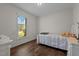Simple bedroom featuring wood laminate flooring, a twin bed, and a bright window at 309 Old Farm Dr, Graham, NC 27253