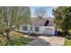 Charming single-story home with white siding, a garage, and a well-maintained front yard with mature trees at 309 Old Farm Dr, Graham, NC 27253