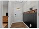 Inviting foyer featuring stylish wood-look flooring, coat hooks, and a well-lit entryway with a half-moon window at 309 Old Farm Dr, Graham, NC 27253