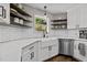 Beautiful kitchen featuring white subway tile, open shelving, and a stainless steel dishwasher at 309 Old Farm Dr, Graham, NC 27253