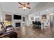 Bright living room with fireplace, opening up to a modern kitchen with bar stool seating at 309 Old Farm Dr, Graham, NC 27253