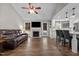 Open-concept living area with a fireplace, modern kitchen with breakfast bar, and access to the outdoors at 309 Old Farm Dr, Graham, NC 27253