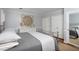 Well-lit bedroom featuring neutral paint, two closets, and a striking, symmetrical art piece at 3508 Cambridge Rd, Durham, NC 27707
