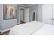 Bright bedroom features a light gray wall color, white trim and a painting to the left of the bed at 3508 Cambridge Rd, Durham, NC 27707
