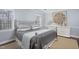 Comfortable bedroom with a decorative silver bed frame, neutral walls, and ample natural light at 3508 Cambridge Rd, Durham, NC 27707