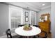 Cozy dining room with white table, black chairs, and sunlit windows creating a welcoming atmosphere at 3508 Cambridge Rd, Durham, NC 27707