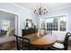 Elegant dining room featuring a chandelier, bay window, and stylish decor, perfect for entertaining at 3508 Cambridge Rd, Durham, NC 27707